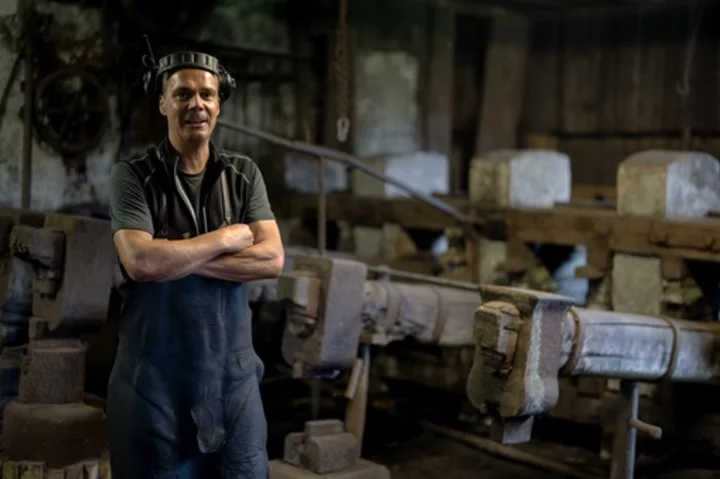 AP PHOTOS: Bavarian hammersmith forges wrought-iron pans at a mill more than 500 years old