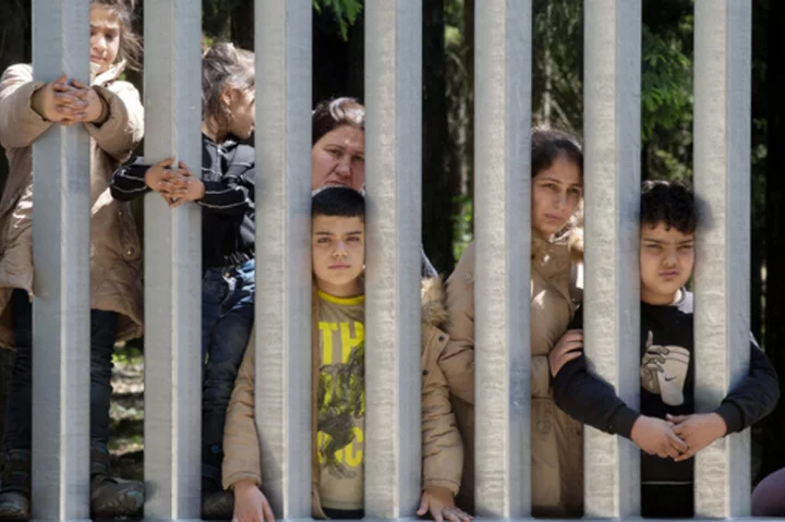 Migrants with children stuck at Poland's border wall; activists say Belarus won't let them turn back