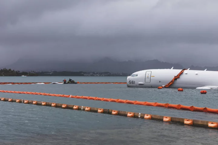 US Navy removes fuel from plane that overshot Hawaii runway and is now resting on a reef and sand