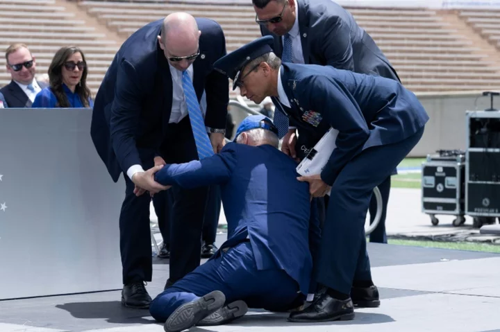 Biden trips, tumbles on Air Force stage