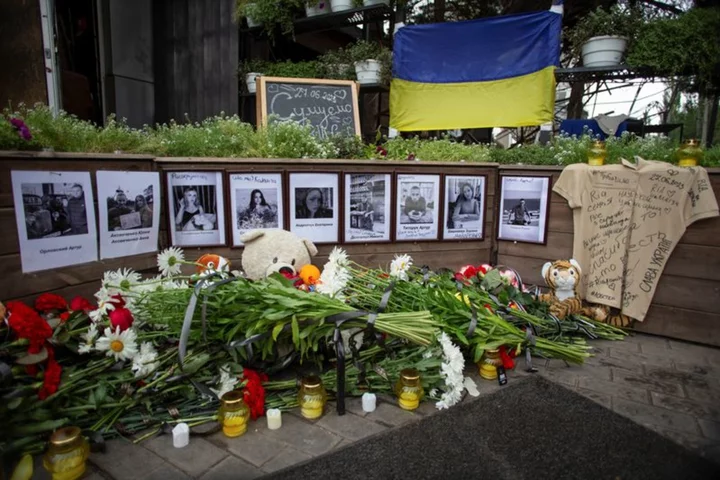 A devastated mother bids farewell to twin daughters killed in Russian strike