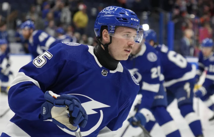 Lightning left wing Cole Koepke wearing neck guard following the death of Adam Johnson