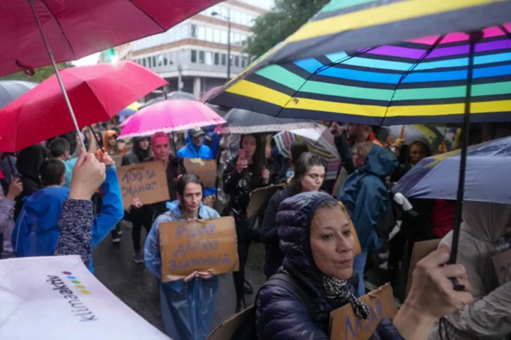 Protesters encircle Serbian state TV building to press government to ease its grip on media