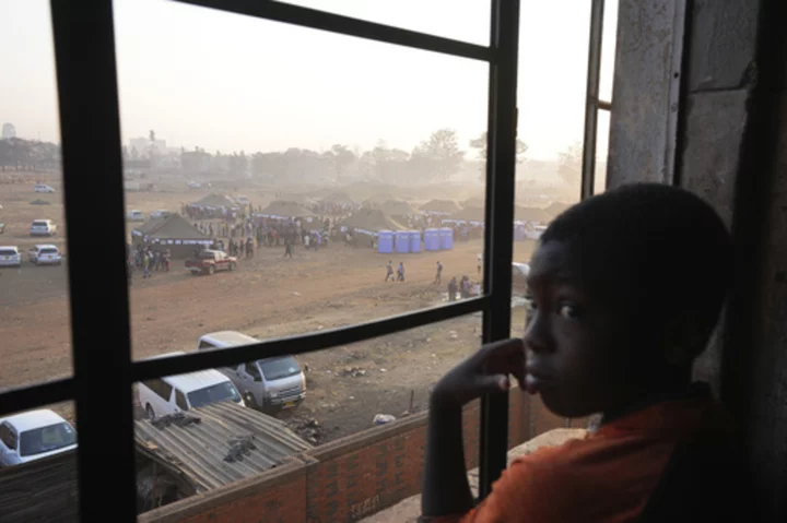 Zimbabwe's election extends to a second day after long ballot delays. Some slept at polling stations