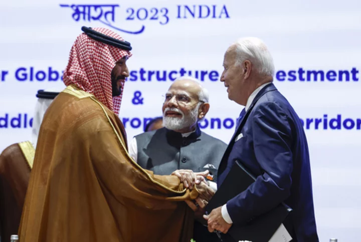 Biden gives Saudi Crown Prince Mohammed a hearty handshake a year after an awkward fist bump moment