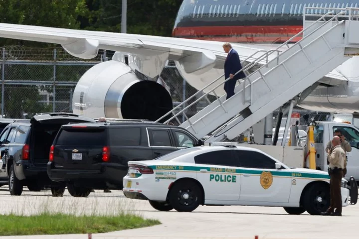 Trump arrives in Florida to face charges, maintains lead in poll