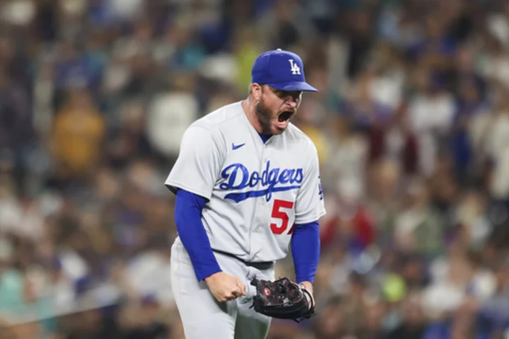 Dodgers wrap up NL West title for 10th time in 11 years with 6-2 win over Mariners in 11 innings